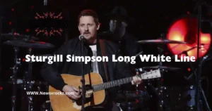 Sturgill Simpson stands beside a long white line, symbolizing a journey or path in his artistic expression.